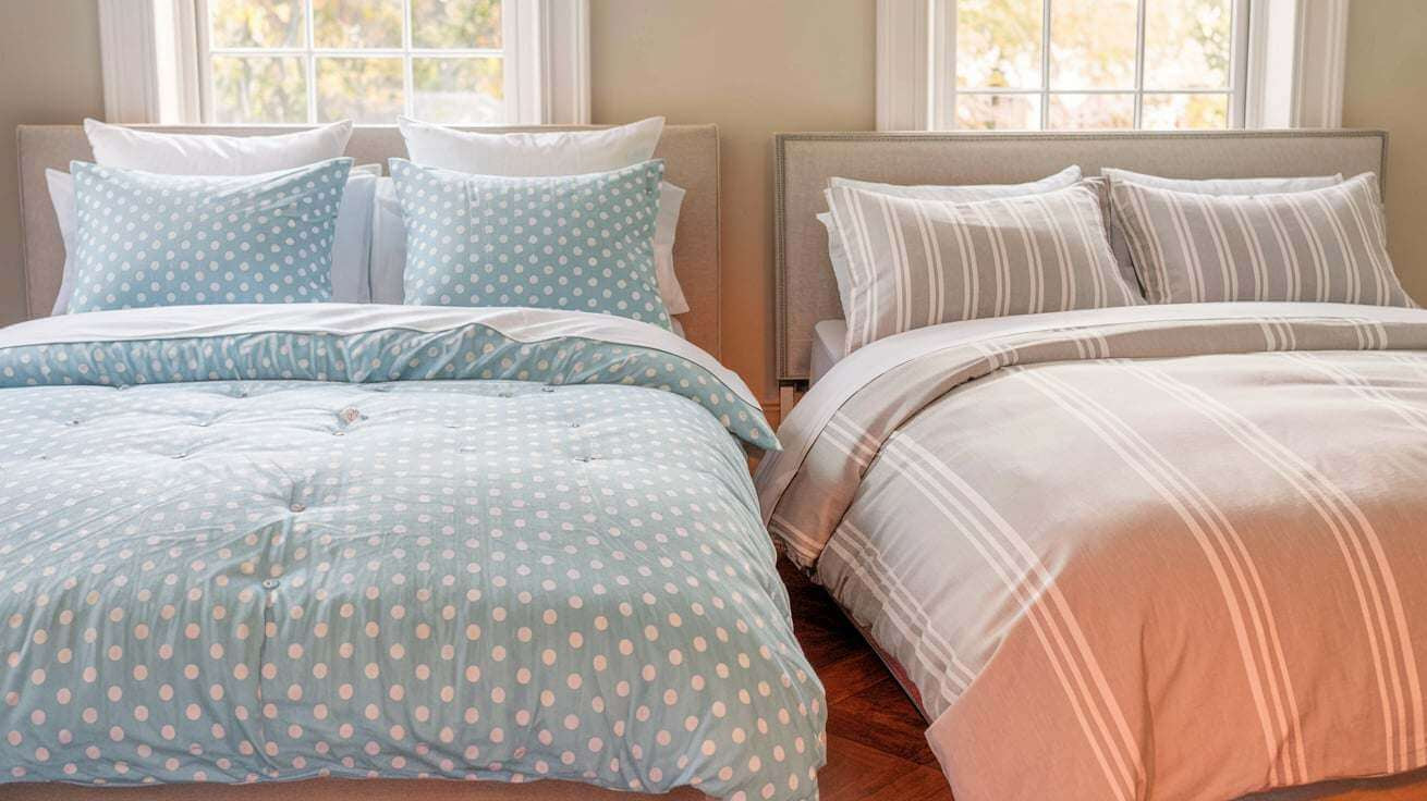 a queen size duvet cover and a king size duvet cover. The queen size duvet cover is light blue with white polka dots and has a button closure.