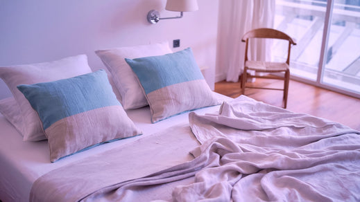 a bed with linen sheets. The sheets are white and they are neatly folded