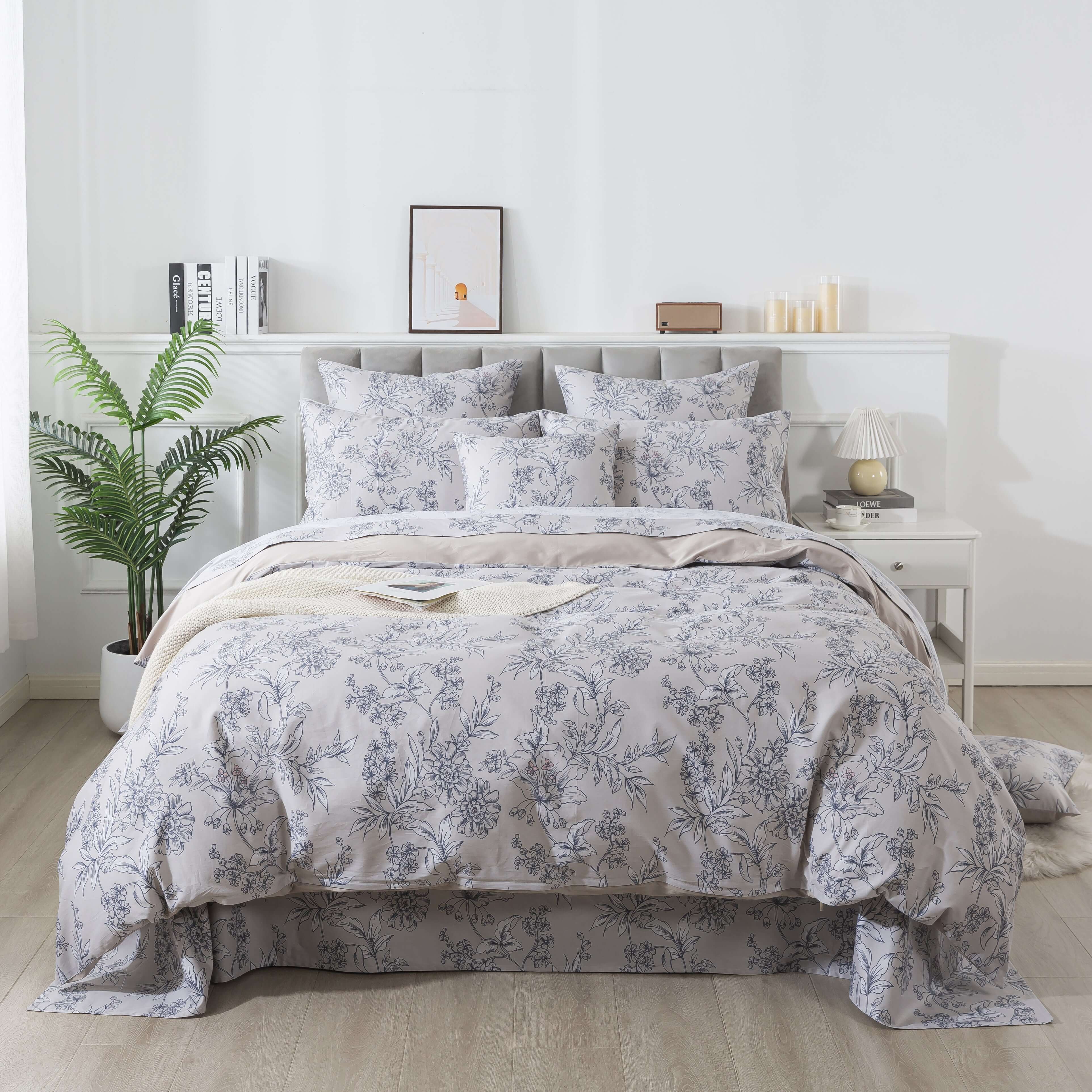 A cozy bedroom with warm bedding on the bed and a floral duvet cover wrapped in a duvet